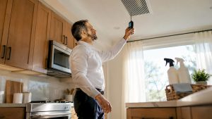 Technician inspecting HVAC vent for odors