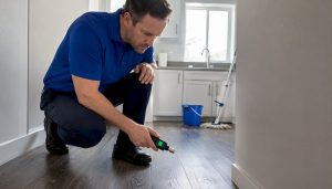 Inspector checking air vent for odors indoors