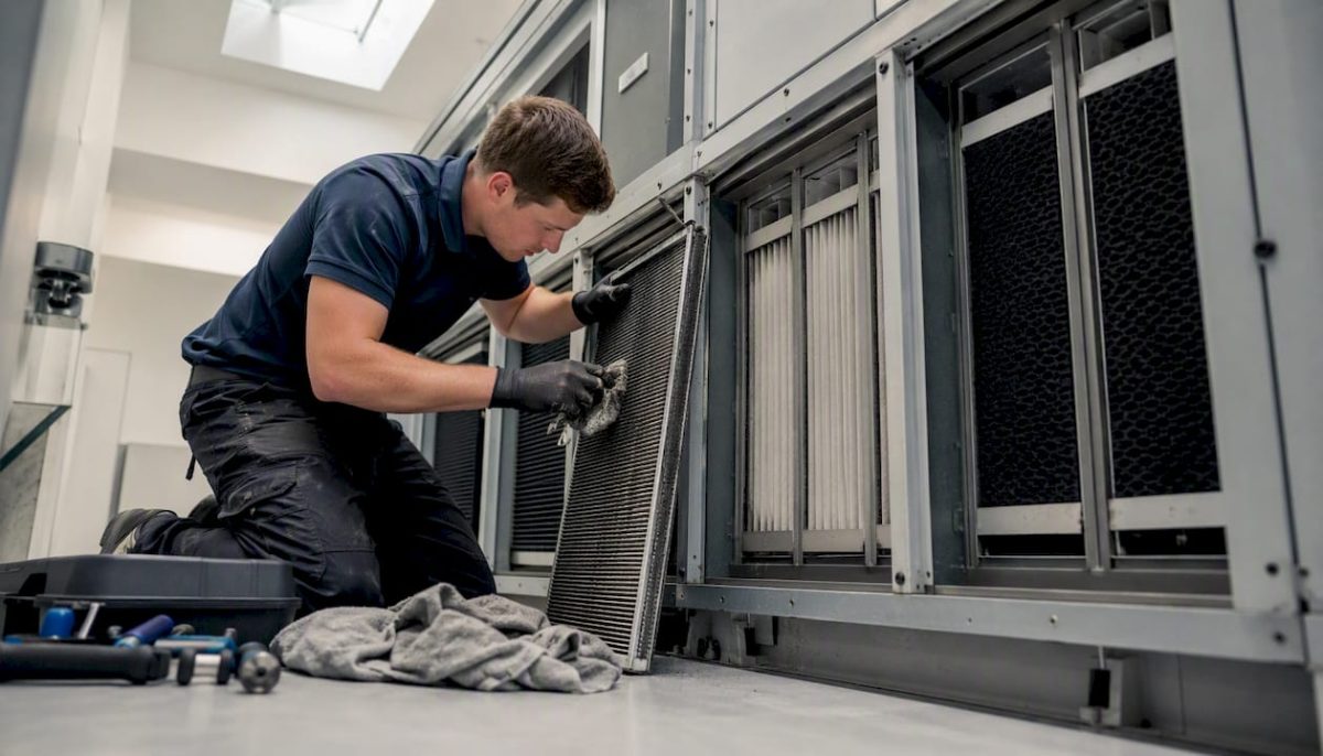Hands cleaning HVAC coil and filters