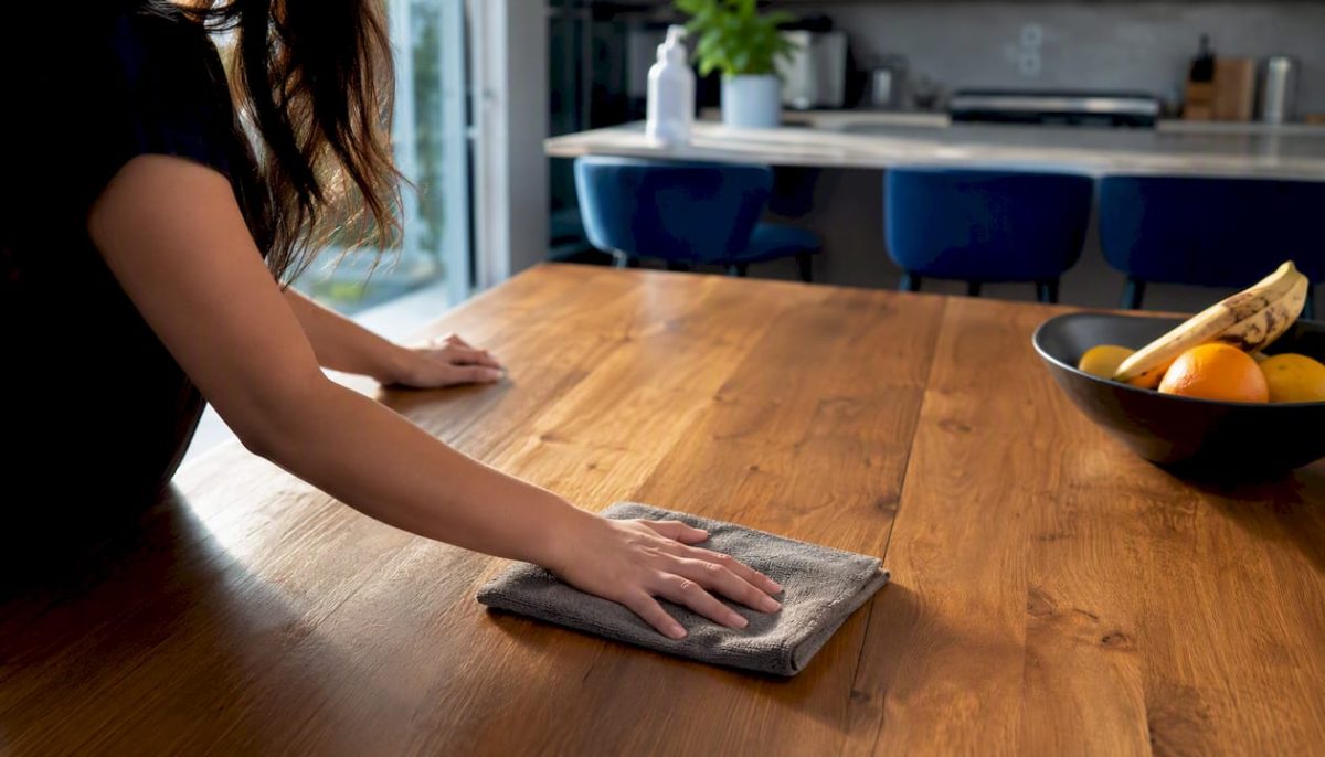 Hands cleaning delicate marble and wood surfaces