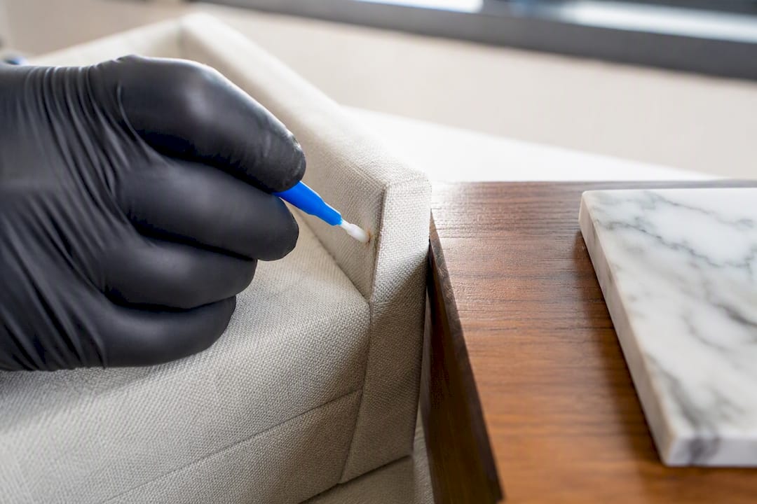 Technician testing treatment on interior materials